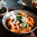 A big bowl of the resultant style creamy red pepper pasta, sitting on a countertop.