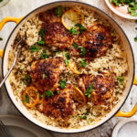 A big pot of the one pan greek chicken and lemon rice, sitting on a countertop