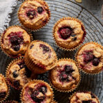 A dozen of the gluten-free triple berry muffins, laid out on a cooling rack.