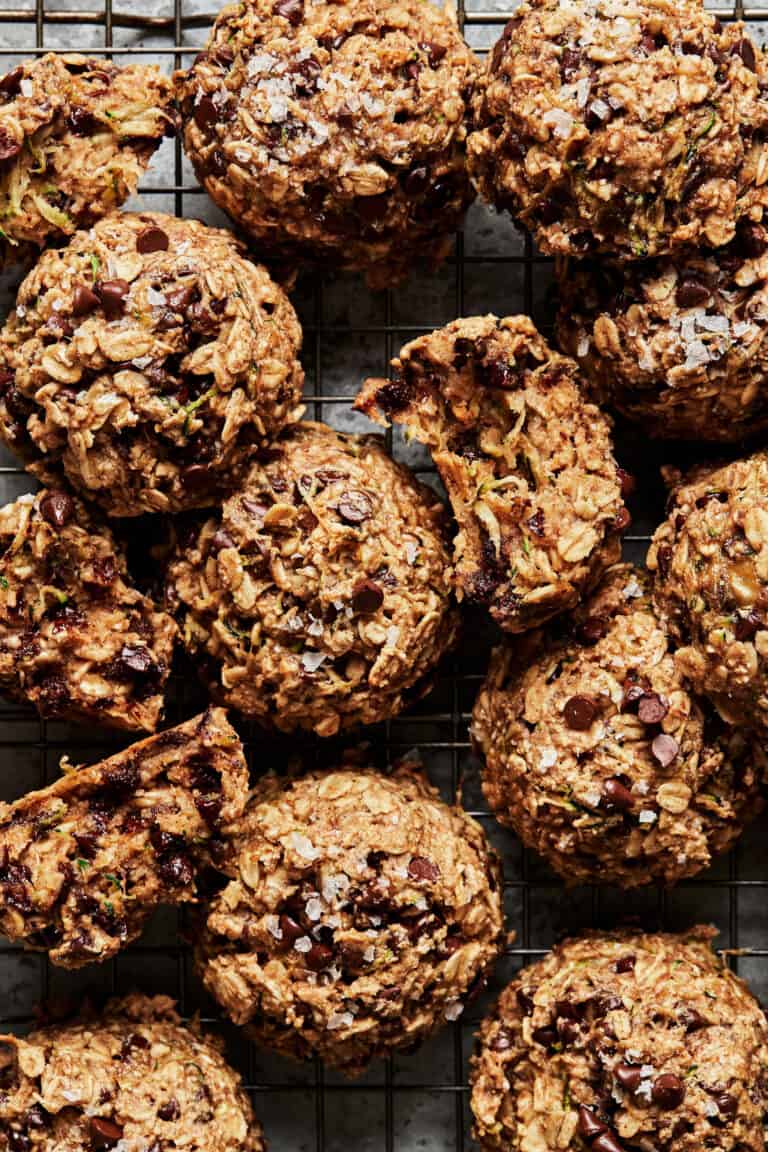 A bunch of the vegan chocolate chip cookie zucchini breakfast cookies, sitting on a cooling rack.