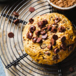 A cooling rack, sitting on a counter, with the single serving scone on top