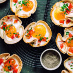 A tray full of the tortilla egg cups, lined up on a metal cooling rack