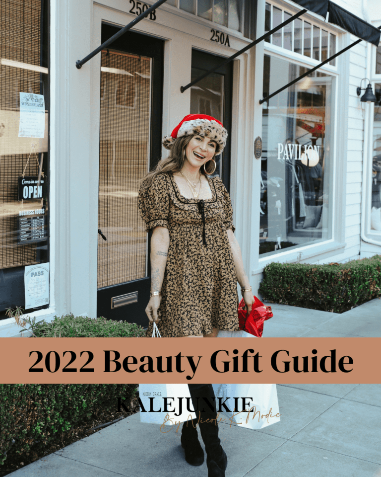 An image of Nicole K. Modic, wearing a Santa hat, with the words "2022 beauty gift guide" written on it