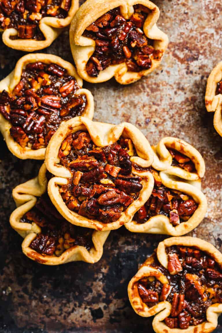 A stack of the mini pecan pies, sitting on a countertop