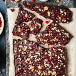 A tray of the pomegranate walnut chocolate bark, broken into pieces and laid out on a baking sheet