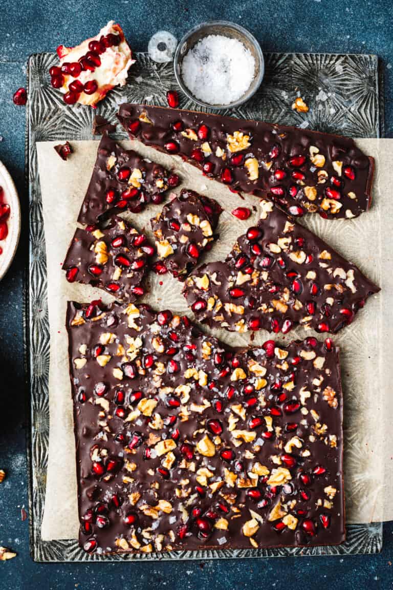 A tray of the pomegranate walnut chocolate bark, broken into pieces and laid out on a baking sheet