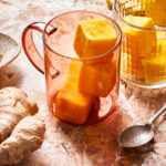 A glass of the immunity cubes, sitting on a tall glass, on a countertop