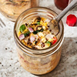 A close-up image of one of the meal prep mason jar omelettes, sitting on a countertop