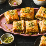 A plate of the pistachio walnut baklava, sitting on a countertop