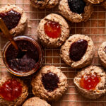 A wire cooling rack, topped with the famous golden door jam cookies