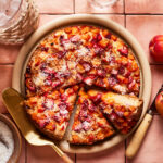 The Healthy Strawberry Apricot Snacking Cake, sit-in g on a counter with a few slices cut into it