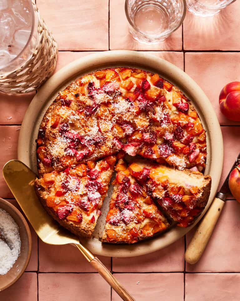 The Healthy Strawberry Apricot Snacking Cake, sit-in g on a counter with a few slices cut into it