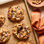 A tray filled with the 5 ingredient magic cookies, sitting on a countertop with one of the cookie cracked in half