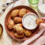 A big plate full of the easy veggie chicken nuggets, sitting alongside a bowl of homemade ranch dressing