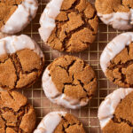 A close-up image of a batch of the soft baked gingerbread cookies, laid out on a wire cooling rack
