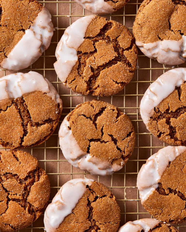 A close-up image of a batch of the soft baked gingerbread cookies, laid out on a wire cooling rack