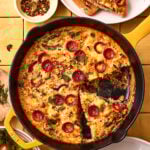 An image of the easy pizza frittata, sitting in a cast iron skillet on a countertop
