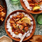 A bowl of the saucy lemon garlic teriyaki chicken, sitting atop a bed of white rice