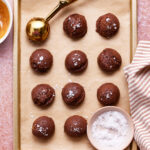 A tray of the no-bake tagalong cookie bites, sitting on a baking sheet on a countertop