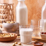 A glass of the salted caramel cashew milk, sitting on a countertop