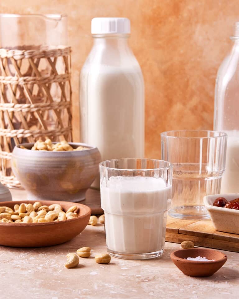 A glass of the salted caramel cashew milk, sitting on a countertop