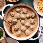 A pot, filled with the baked swedish meatballs, swimming in the sauce