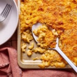 A sheet pan of the chili mac n cheese, with a spoon resting on the tray