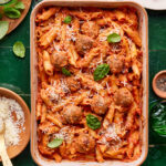 A tray of the easy baked penne with meatballs, sitting on a countertop