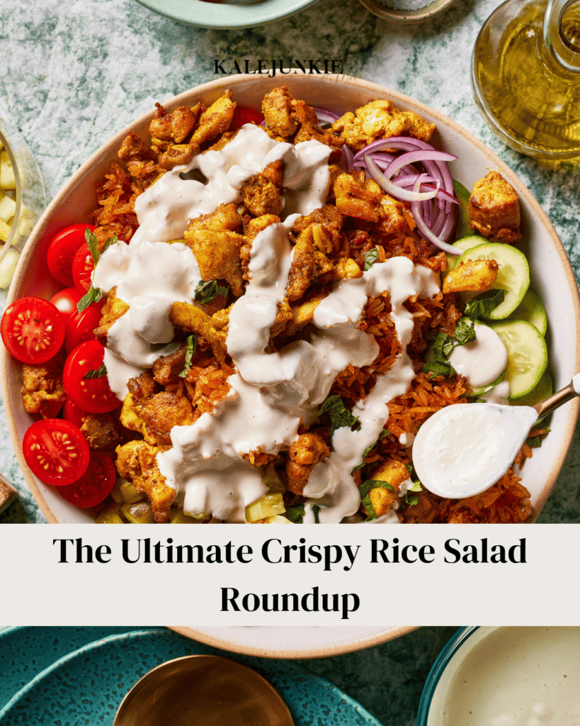 A bowl of crispy rice salad topped with cauliflower, tomatoes, cucumber slices, red onion, and drizzled with creamy dressing. A dollop of yogurt is on the side. Text reads, "The Ultimate Crispy Rice Salad Roundup.