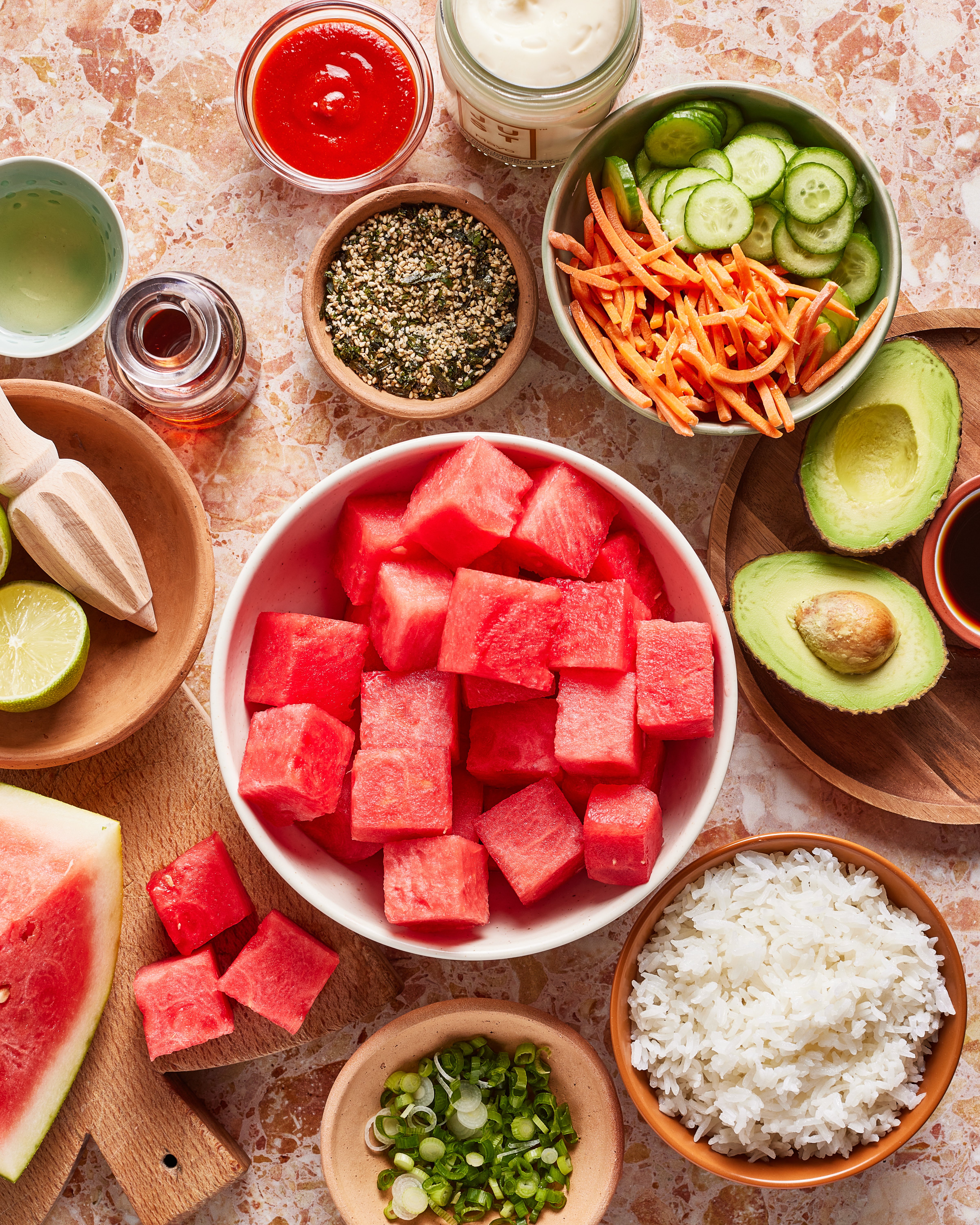 To make this crispy rice watermelon poke, you’ll need rice, sesame oil, coconut aminos, watermelon, sriracha, rice vinegar, vegan mayo, lime juice, cucumbers, avocado, carrots, scallions, and furikake.
