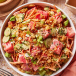 A bowl of crispy rice watermelon poke on a table.