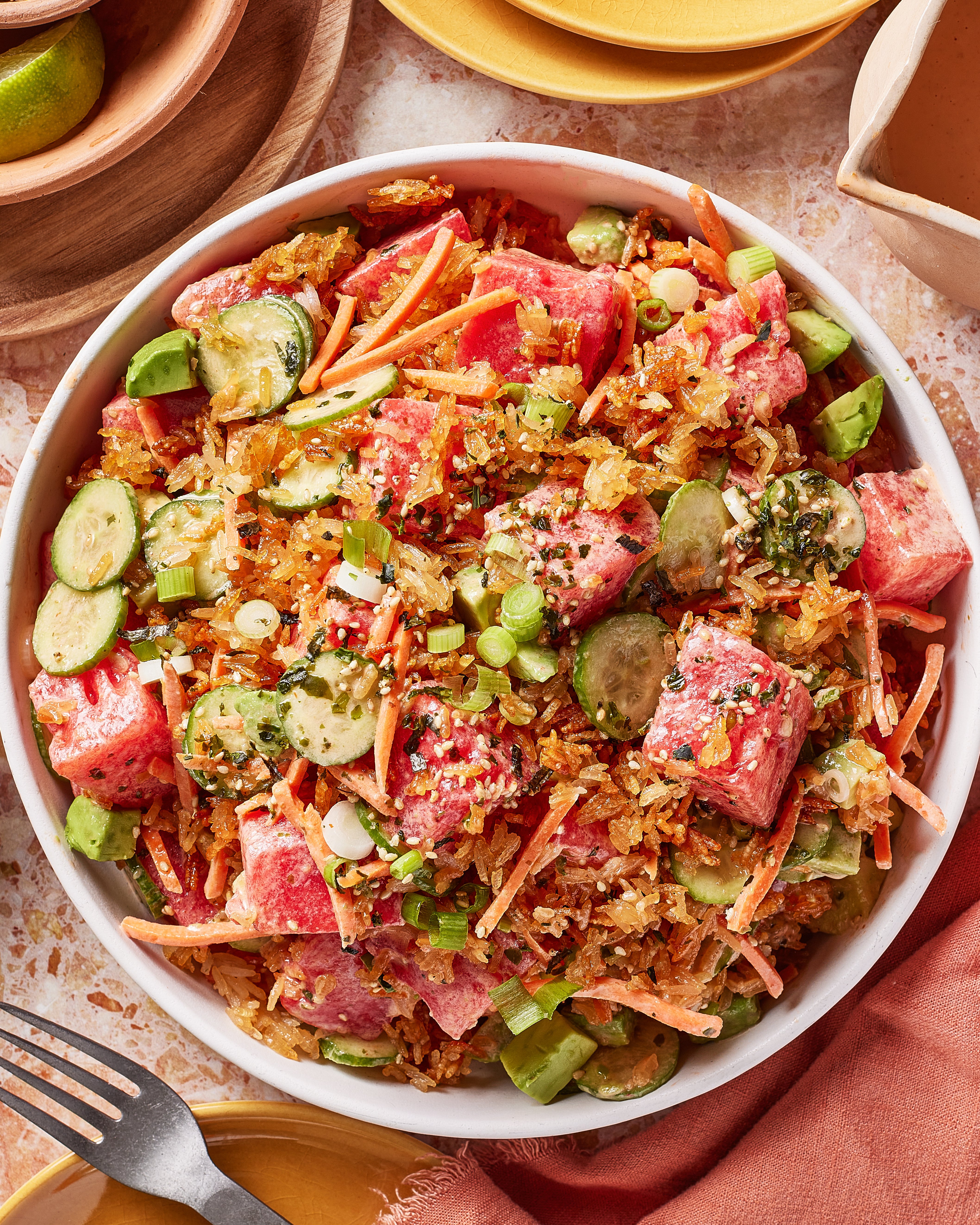 A bowl of crispy rice watermelon poke on a table.