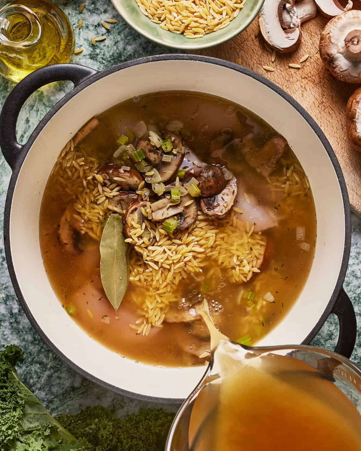 A bowl of soup with rice and mushrooms.