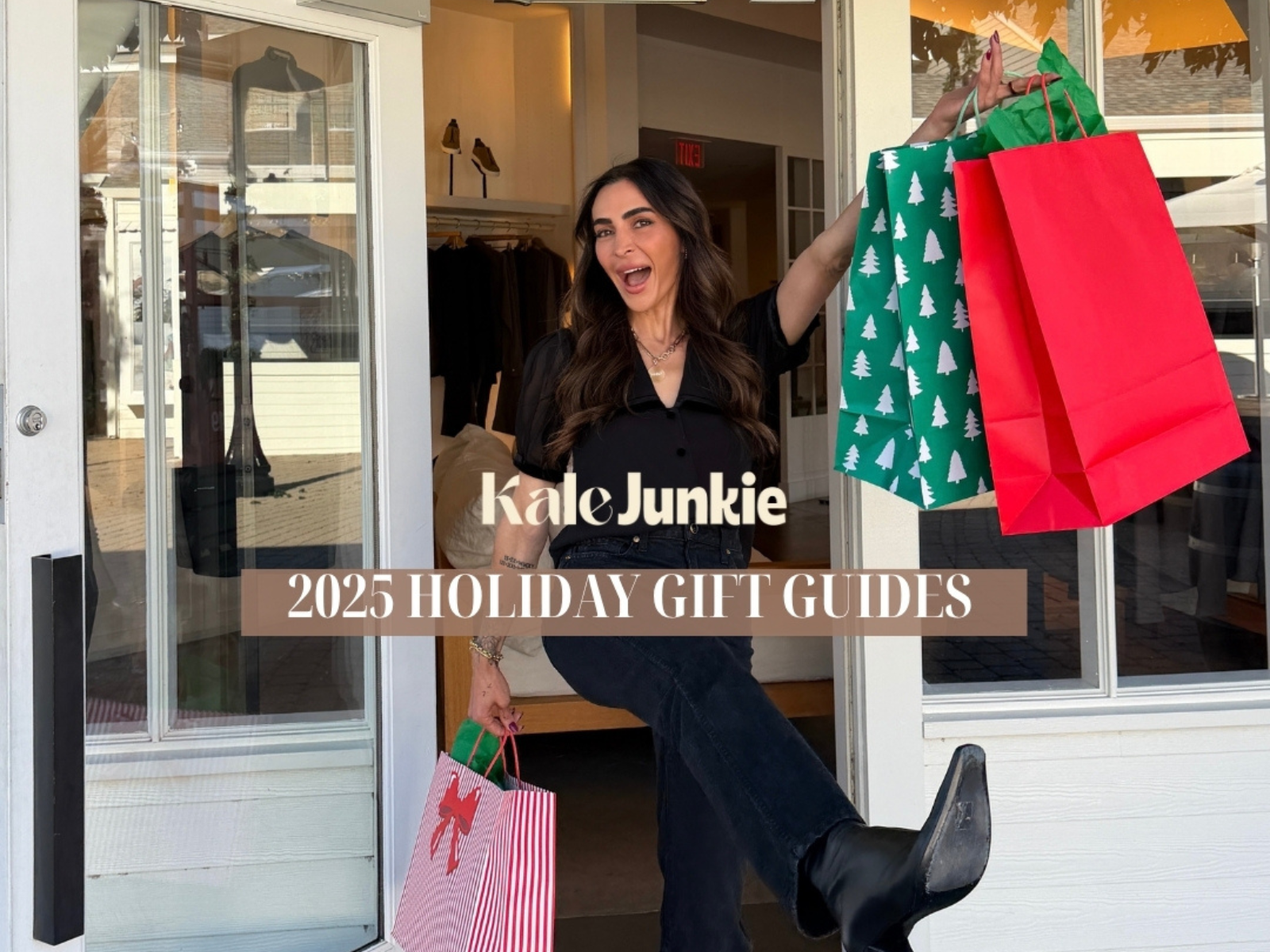 A smiling woman stands in a doorway holding festive holiday gift bags. Text on the image reads “Kale Junkie 2025 Holiday Gift Guides.”.
