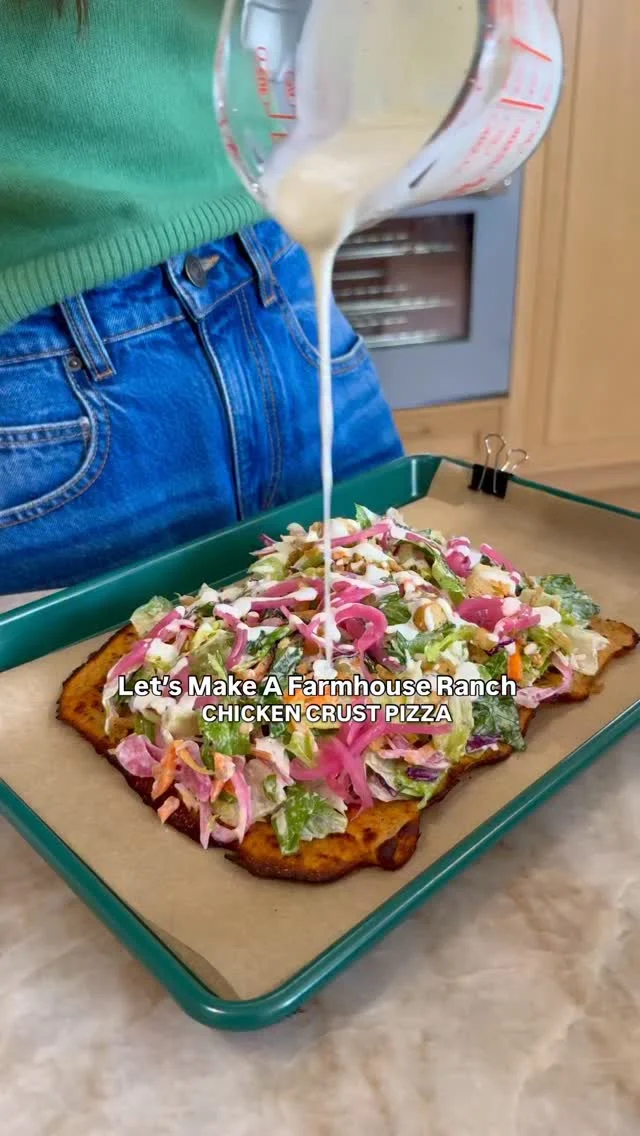 FARMHOUSE RANCH CHICKEN CRUST PIZZA, made with the Fresh Express Farmhouse Ranch Chopped Salad Kit! #ad Fresh Express makes it easy to express yourself by taking any of their delicious salad blends and putting your own creative spin on them to make something you are excited to eat. In this case, I took the viral chicken crust pizza trend and used it as the perfect high-protein base for the @yourfreshexpresssalad Farmhouse Chopped Salad. I also added homemade pickled onions to make it extra special and tangy! It is so good!⁣
⁣
I can’t wait for you to make this recipe or pick up any one of the Fresh Express salad kits and Express Yourself by getting creative in the kitchen. The full recipe is below and on FreshExpress.com. #FreshExpress #ExpressYourself⁣
⁣
Makes 1 pizza⁣
Pizza Crust⁣
1 lbs. ground chicken⁣
1/2 cup freshly grated parmesan cheese⁣
1 egg⁣
1/4 cup barbecue sauce⁣
1 tb Italian seasoning⁣
1/2 tsp garlic powder ⁣
1/2 tsp kosher salt ⁣
1/2 tsp ground black pepper⁣
⁣
Topping⁣
1 bag Fresh Express Farmhouse Ranch Chopped Salad Kit⁣
1/4 cup pickled red onions⁣
⁣
Preheat oven to 400F. Line a quarter sheet baking tray with parchment paper and set aside. In a food processor, add all of the ingredients for the chicken crust, and process until smooth. Using a spatula, spread the chicken mixture into an even, thin layer on the baking sheet. Bake for 25 to 26 minutes until the edges get brown and crispy. Remove the crust from oven and let cool to harden. Next, add the Fresh Express Farmhouse Ranch Chopped Salad Kit to a large bowl. Toss with dressing, then add the salad mixture on top of the chicken crust. Garnish with pickled onions, slice, and enjoy immediately!