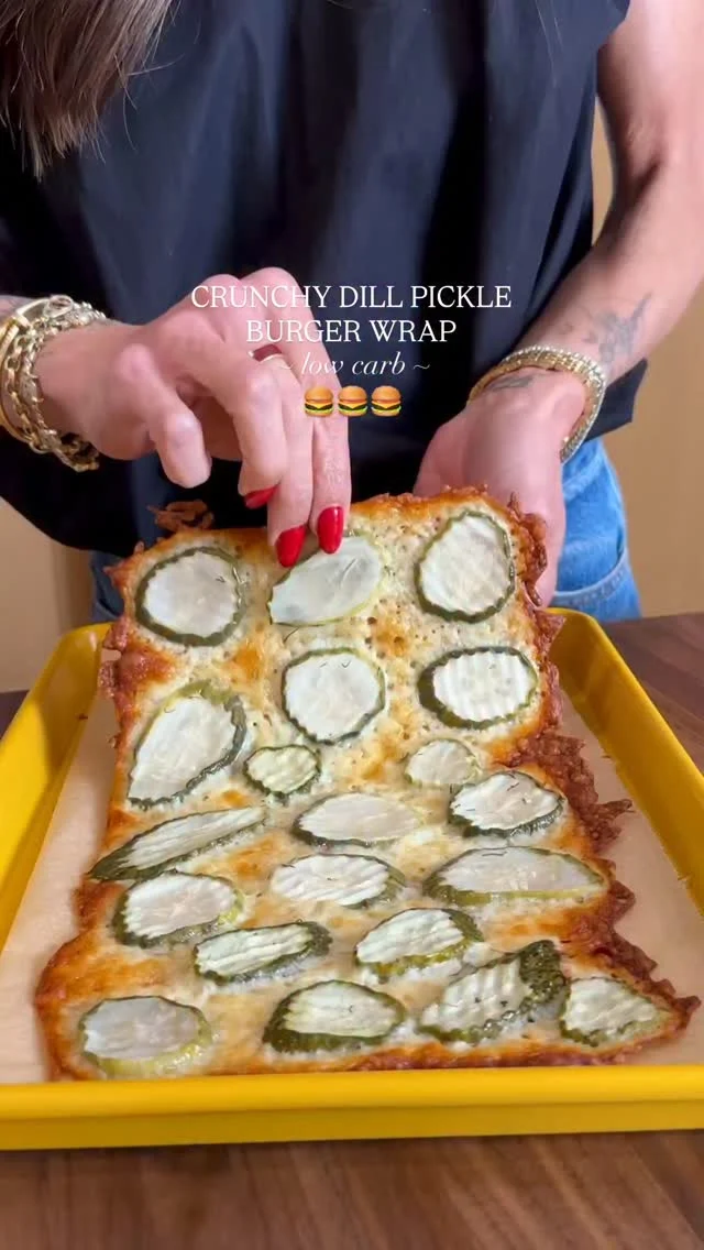 @kalejunkie 🍔 CRUNCHY LOW CARB BURGER WRAP—I love real bread, but pls ditch it today and make this delicious dill pickle burger wrap instead. You can fill your wrap with anything you like, but I highly recommend seasoned ground beef, caramelized onions, lettuce, tomatoes, pickles and my protein burger sauce. This recipe makes one large wrap, so share with a friend or store the other half to enjoy the next day. You have to try it!

Makes 1 large wrap
3/4 cup shredded mozzarella cheese
20 dill pickle slices 

Fillings:
Seasoned ground beef
Caramelized onions
Romaine lettuce
Tomatoes
Protein burger sauce

Burger sauce
1/2 cup greek yogurt 
2 tb pickle juice
2 tb ketchup
2 tsp dijon mustard
1/2 tsp garlic powder
1/2 tsp smoked paprika

Preheat oven to 350F. Like a baking sheet with parchment paper. Spread mozzarella evenly on the tray, shaping it with your hands to make it like a rectangle. Dry pickle slices with paper towels to remove as much liquid as possible. Spread the pickles over the cheese, pressing gently into the cheese. Place the tray in the oven and bake for 15 minutes or until the edges have browned. Remove the tray from the oven and let sit to cool and harden for 5-6 minutes. Lift the wrap off the sheet and flip it over. Add your burger fillings on one side of the wrap. Make your burger sauce—add ingredients to a bowl and mix until smooth. Spread over the wrap, then fold it closed. Cut into half and enjoy right away. #viralrecipes #lowcarbrecipes
