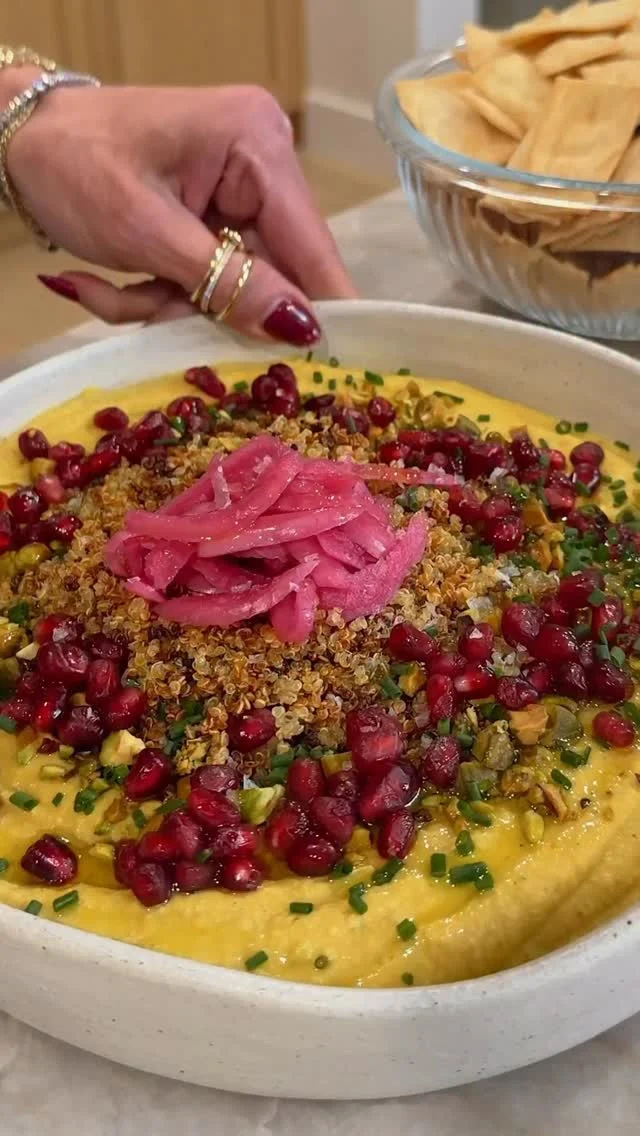 @kalejunkie ✨ my BUTTERNUT SQUASH HUMMUS WITH CRISPY QUINOA is here right in time for the holidays! It is so flavorful, delicious, easy to make—and it’s so pretty! The crispy quinoa on top and the pickled onions are the chefs kiss, with so many different flavors and textures happening all at once. I cannot wait for you to try this 😊. I love serving with pita chips, but it pairs perfectly with a veggie platter too!

PSA: my food processor and baking sheets are on big sale for Black Friday, so comment LINK and I will DM you now! Be sure to SHARE this post FOLLOW @kalejunkie for more recipes like this :)

Makes 8 servings
1 cup cooked quinoa
1 tb olive oil, salt & pepper to taste
2 cups butternut squash (2 cups cubed)
2 tb olive oil
1 tsp cumin, salt & pepper to taste

1 15 oz can garbanzo beans, drained and rinsed
1/4 cup tahini
3 tb olive oil
1 lemon, juiced (1/4 cup)
1 tsp cumin, divided
1 tsp ground turmeric 
2 cloves garlic
1 tsp kosher salt
1/2 tsp ground black pepper
1/4 cup water, if needed to thin
Optional: 1/4 tsp crushed red pepper flakes
Garnishes: pomegranate, pickled onions, chopped pistachios

Preheat oven to 400F. Chop butternut squash and spread it onto a small baking sheet. Toss with a generous drizzle of olive oil, 1 tsp cumin, and a generous pinch of salt and pepper. Bake for 30-35 minutes, tossing the squash halfway through. Remove from oven once fork tender. Meanwhile, on another small baking sheet, add the cooked quinoa. Toss with a generous drizzle of olive oil, salt and pepper. Spread into an even layer and bake for 20-25 minutes, mixing half way through. Be sure to watch carefully so it doesn’t burn. Finally, in a food processor add the roasted butternut squash, tahini, olive oil, lemon juice, cumin, turmeric, garlic, salt, pepper, and red pepper flakes (if using). Process until as smooth as possible, about 3 minutes. If your hummus is too thick, add the water. Once smooth, taste and adjust seasonings as needed. Spread hummus onto a serving plate and top with the crispy quinoa and your other garnishes—pomegranate, chopped pistachios, pickled onions, and chives. ENJOY!
#hummus #hummusrecipe