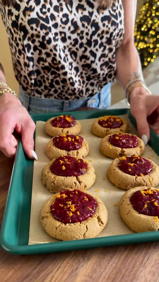 @kalejunkie OVERSIZE RASPBERRY ORANGE THUMBPRINT COOKIES (gluten free, refined sugar free)! I am so obsessed with these cookies and you will be too—soft and flavorful, filled with a heaping scoop of raspberry chia jam. These store well too, for a good-for-you treat you can enjoy all week! ⁣
⁣
Be sure to FOLLOW @kalejunkie for more 🙋🏻‍♀️ and SAVE and SHARE this post with friends! 🫶🏻⁣
⁣
Makes 15 large cookies or 24 smaller⁣
Raspberry jam—⁣
2 1/2 cups frozen raspberries, thawed⁣
3 tb chia seeds⁣
3 tb maple syrup⁣
1 tb cornstarch/arrowroot/tapioca⁣
⁣
Cookies—⁣
1 cup cashew butter⁣
2 eggs (sub: flax eggs)⁣
1/3 cup maple syrup⁣
1/2 cup coconut sugar⁣
1 tb vanilla extract ⁣
1 tb orange zest⁣
3 tb orange juice⁣
1 1/4 cups coconut flour (may need 2 tb more depending on how liquidy your cashew butter is!)⁣
1/2 tsp baking soda⁣
⁣
Preheat oven 350. Make the jam. Add all of the ingredients except cornstarch and stir. Bring to a low boil, then turn to low heat and simmer for 10 minutes. Next, mix 2 tablespoons water and cornstarch forming a slurry. Add the slurry and stir. Remove from heat and allow to cool and further thicken for 15-20 minutes. While jam is cooking, make the cookies. In a medium bowl, beat together the cashew butter, eggs, maple syrup, coconut sugar, vanilla, orange zest and juice until smooth. Add the coconut flour and baking soda, and mix until there are little to no clumps. Let the dough sit for 3-5 minutes so the coconut absorbs, making the dough easy to work with. If its not, add 1 tablespoon more. Line a baking sheet with parchment paper. Oil your hands so it’s easy to form balls. Take 2-3 tablespoons of dough and a form a ball and place on baking sheet. Repeat. Allow space for the cookies to spread a bit. Use your thumb or measuring spoon to make a large indent in the center of each ball and bake for 9-10 minutes. When they come out of the oven, press the indent again. Cool for 10 minutes, then add 1 heaping tablespoon of jam into each cookie, more orange zest if desired, and serve. #holidaycookies #thumbprintcookies #healthybaking⁣
⁣
⁣