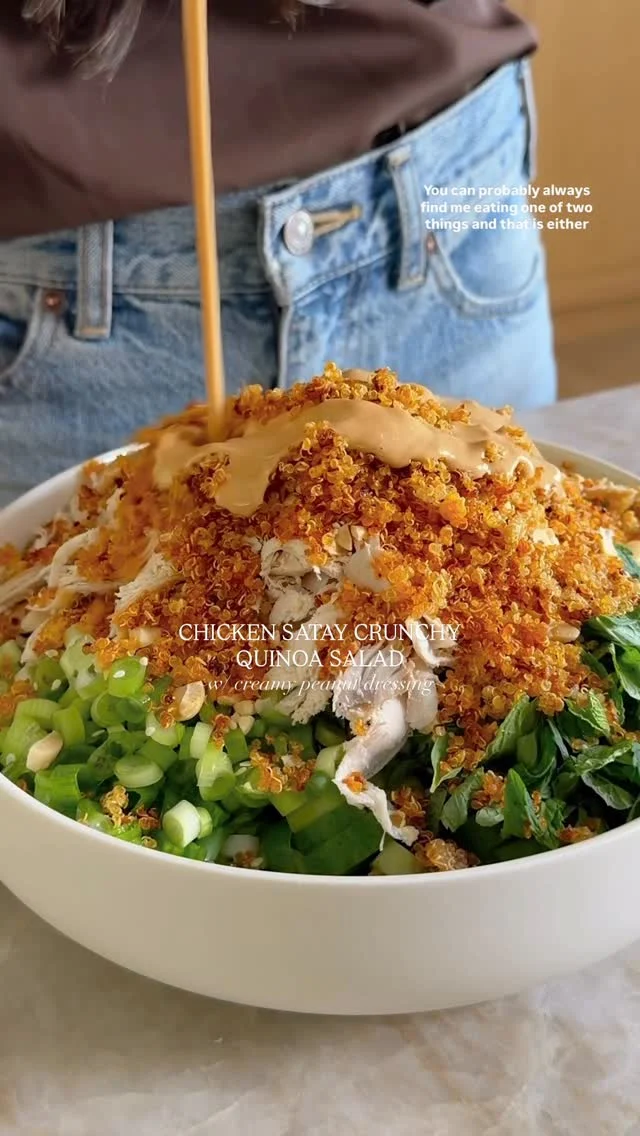 @kalejunkie 👈🏼👉🏼 NEW! CHICKEN SATAY CRUNCHY QUINOA SALAD and my gosh I am starting the new year with a salad you don’t want to miss ☺️ Using a rotisserie chicken to save time and adding crunchy quinoa on top for added fiber and protein, this a filling, meal size dinner you’ll be making on repeat. ⁣
⁣
Comment LINK for everything used in this video!⁣
⁣
Makes 4 servings ⁣
Crunchy quinoa⁣
1 cup cooked quinoa⁣
2 tsp sesame oil⁣
2 tsp low sodium soy sauce ⁣
1 tsp chili crisp⁣
⁣
Peanut dressing⁣
1/2 cup peanut butter 
1/4 cup water⁣
1/4 cup low sodium soy sauce ⁣
1/4 cup rice vinegar⁣
2 tb chili sauce⁣
1 tb fish sauce ⁣
⁣
Salad⁣
2 1/2 cups rotisserie chicken, shredded⁣
4 persian cucumbers, chopped⁣
1 cup shelled edamame⁣
1 small bunch cilantro, chopped⁣
1 small bunch mint, chopped⁣
1 bunch green onions, chopped⁣
1/4 dry roasted peanuts, crushed ⁣
1 small bunch Thai basil, chopped⁣
⁣
Preheat oven to 375F. Add cooked quinoa to a baking sheet. Toss with the oil, soy sauce and chili crisp and spread into an even layer. Bake 20-25 minutes or until golden and crunchy. While that’s in the oven make the dressing. Add all of the dressing ingredients to a mini blender and blend until smooth. Finally, build your salad. In a large bowl, add the shredded chicken, and remaining salad ingredients. Top with crunchy quinoa. Pour dressing on top, toss and enjoy!⁣
⁣
salad recipes | viral salads | crispy quinoa | good nutrition | healthy eating | meal salads