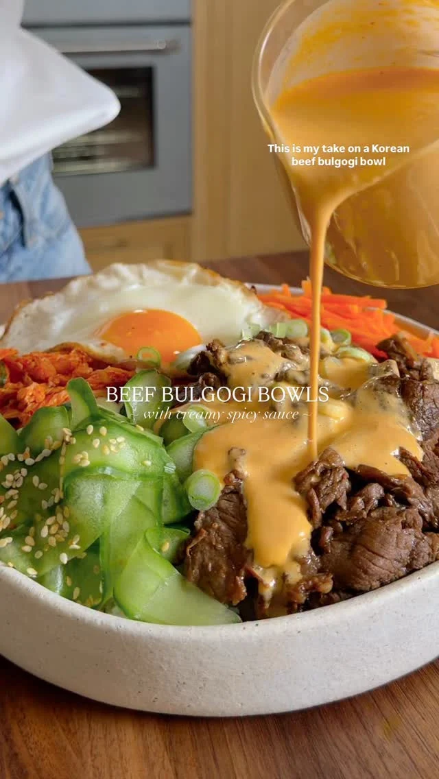 @kalejunkie NEW 😍 BEEF BULGOGI BOWLS WITH SPICY SAUCE, my latest dinner obsession! If you can’t get to a Korean restaurant, try my version (like tonight 😏). The meat sliced thin melts in your mouth and it’s paired with rice, sliced cucumbers, kimchi, a fried egg and then drizzled with my spicy sauce that many of you already know and love! ⁣
⁣
SAVE this post, SHARE with friends, and FOLLOW me @kalejunkie for more easy recipes!⁣
⁣
Makes 4 servings ⁣
BULGOGI MEAT⁣
1/2 cup low sodium soy sauce ⁣
1/3 cup packed coconut sugar⁣
2 tb sesame oil ⁣
2 tb chili garlic sauce⁣
1/4 cup rice wine vinegar⁣
2 cloves garlic, mashed⁣
1 tb freshly grated ginger⁣
1/2 tsp kosher salt⁣
1 large shallot, sliced thin⁣
2 1/4 lbs top sirloin steak, cut into 1/4 inch pieces⁣
2 tb avocado oil⁣
⁣
SPICY SAUCE⁣
1 cup plain greek yogurt⁣
1/4 cup sriracha⁣
2 tb rice vinegar⁣
1/4 cup low sodium soy sauce⁣
2 tb honey⁣
1 tsp fresh grated ginger⁣
1/2 tsp crushed red pepper flakes⁣
⁣
FOR THE BOWLS⁣
3 cups cooked rice⁣
4 fried eggs⁣
1 cup homemade or store-bought kimchi ⁣
1 English cucumber, cut into ribbons⁣
Optional: sesame seeds⁣
⁣
Start by making the spicy sauce. In a blender, add the yogurt, vinegar, soy sauce, honey, sriracha, and red pepper flakes. Blend until creamy and smooth. Set that aside, and prepare the meat. Slice the steaks into thin pieces and place them in a large bowl. Pro tip: the meat will be much easier to slice thin when semi frozen, so I recommend freezing the meat for about 30 minutes beforehand. Next, make the marinade. In a bowl, whisk together the soy sauce, coconut sugar, sesame oil, chili garlic sauce, vinegar, garlic, ginger, and salt. Pour the marinade over the meat. Add the sliced shallots to the bowl. Toss together well, cover and let marinate for 30 minutes or up to 3 hours. Heat a large pan over high heat. Add the avocado oil. Once the pan is hot, add the beef in small batches, searing quickly on all sides, then removing from the pan and transferring to a plate. Once all the meat is cooked, assemble the bowls. Begin with rice, top with the beef, then a fried egg, sliced cucumber, and kimchi. Drizzle the spicy sauce on top and enjoy!⁣