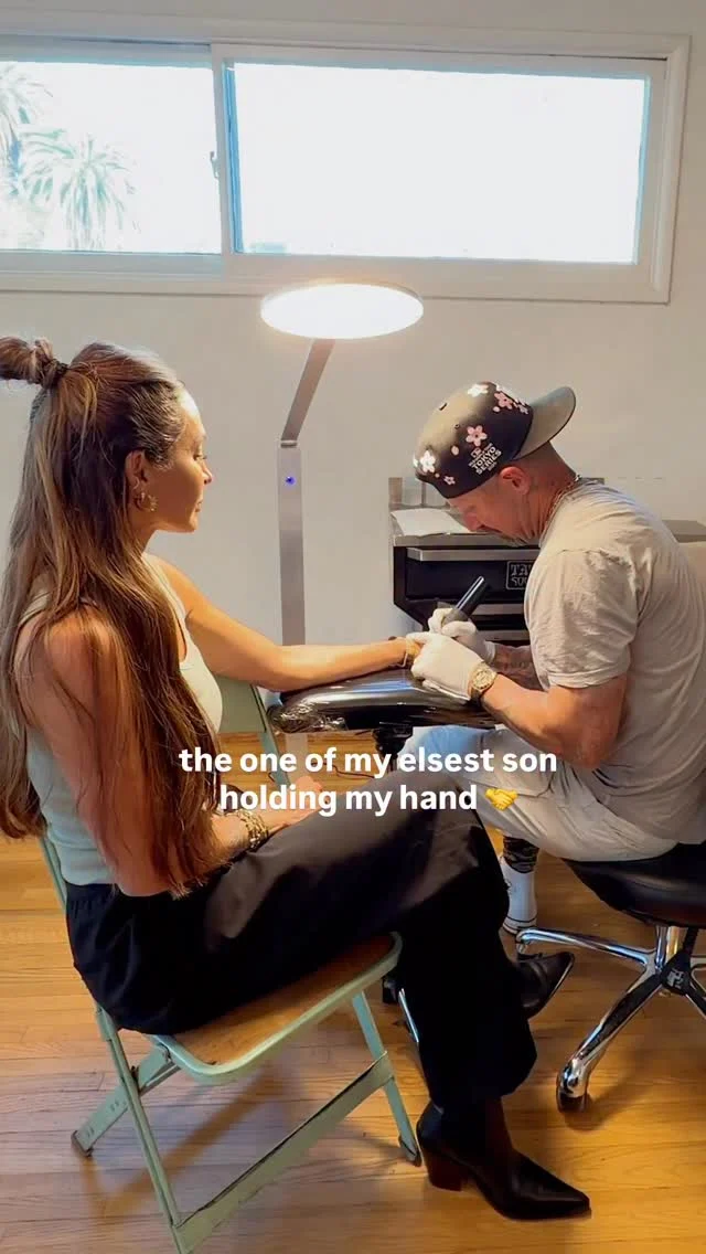 All of my tattoos have meaning—I don’t get them just to get them. There’s intention. I wanted to remember what it was like having my oldest son hold my hand—where his fingers rested on my hand. So this is that.