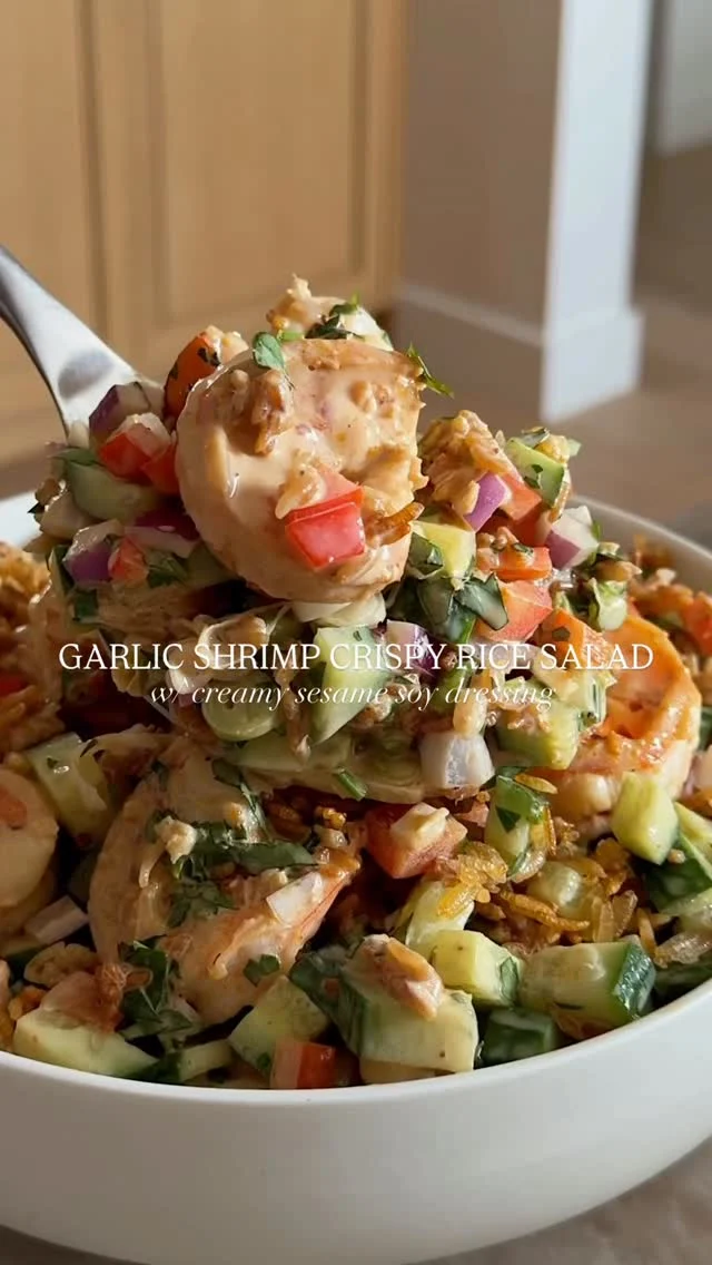 @kalejunkie ✨ GARLIC SHRIMP CRISPY RICE SALAD with creamy sesame soy dressing. If there was ever a salad to make of mine, let it be this — it might just change your life 😉. We’ve got tons of veggies and jumbo garlic shrimp and a dressing so good, you’ll want to drink it on its own!⁣
⁣
SAVE this post, SHARE with friends, and be sure to FOLLOW me @kalejunkie so you don’t miss new recipe drops! ⁣
⁣
Makes 4 servings⁣
CRISPY RICE—⁣
2 cups cooked rice, cooled (I used jasmine rice)⁣
2 tsp sesame oil ⁣
2 tsp soy sauce⁣
⁣
SESAME SOY DRESSING ⁣
3/4 cup fat free greek yogurt ⁣
1/4 cup tahini⁣
2 tb honey⁣
2 tb rice vinegar ⁣
2 tb low sodium soy sauce⁣
⁣
SALAD⁣
1 lb peeled, deveined shrimp ⁣
2 tsp olive oil⁣
3 cloves garlic, minced⁣
1 lemon, juiced ⁣
1/4 crushed red pepper flakes⁣
4 Persian cucumbers, chopped⁣
1/4 red onion, finely diced⁣
1 red bell pepper, finely diced⁣
1/4 cup parsley, chopped⁣
1/4 cup green onions, chopped ⁣
⁣
First, prepare the crispy rice topping. Preheat oven to 400F. Add cooked and cooled rice to a baking sheet. Toss with the sesame oil and soy sauce. Bake for 20-22 minutes, tossing half way through (watch to make sure it doesn’t burn). While the rice is in the oven, make the garlic shrimp. Add olive oil to a skillet over medium heat. Once the skillet is hot, add the garlic, along with the shrimp, lemon juice and red pepper flakes. Stir until fully cooked through, then remove from heat. Remove the crispy rice from the oven and set aside. Next, chop/slice all of the ingredients for the salad and add to a large bowl. Add the cooked shrimp and crispy rice on top. Make the dressing. Blend ingredients for the dressing until smooth & creamy. Taste and adjust seasonings as needed. Pour over the salad. Toss and enjoy! ⁣
⁣
Viral recipes | crispy rice salad | macro friendly