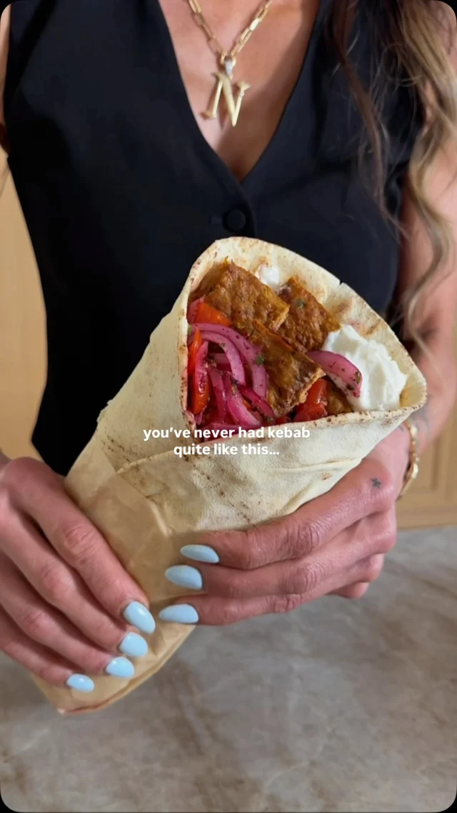 @kalejunkie new! SHEET PAN ADANA-STYLE CHICKEN KEBAB! You will never make kebab any other way again once you start making it this way. This is the latest and greatest version of my viral sheet pan kebabs—healthy, high protein, packed with flavor, and EASY to make on a weeknight or any time you are craving middle eastern food 😍. ⁣
⁣
FOLLOW me @kalejunkie for more recipes like this and comment LINKS for everything I used in this video!⁣
⁣
Makes 4 servings⁣
2 lbs ground chicken⁣
1 red bell pepper, chopped⁣
4 cloves garlic⁣
1 small onion, chopped⁣
1/4 cup parsley⁣
3 tb tomato paste⁣
2 tsp turmeric⁣
2 tsp paprika⁣
2 tsp cumin⁣
2 tsp Aleppo pepper (or 1 tsp crushed red pepper flakes)⁣
1 tsp kosher salt⁣
⁣
Served with:⁣
Low carb pita wrap (@cutdacarb)⁣
Garlic spread (@toom)⁣
⁣
Sumac onion salad⁣
1/2 red onion, thinly sliced⁣
1 cup baby tomatoes, quarterd⁣
1 tb sumac⁣
1 tb red wine vinegar⁣
1/2 tsp kosher salt⁣
⁣
Preheat oven to 375F. Prepare the chicken mixture. Add the bell pepper, onion, garlic, and parsley to a small food processor and blend until the mixture is liquidy. Transfer to a bowl and use a paper towel to press out as much moisture as possible. Add the chicken to a bowl, along with the mixture, and add in the tomato paste, turmeric, cumin, paprika, Aleppo pepper (or red pepper flakes), and salt. Mix until fully incorporated, then transfer the meat mixture to a greased quarter sheet pan and spread it into an even, flat layer. Use a knife to score the beef horizontally and vertically, just like you would see at a restaurant — this will make it easy to cut into individual kebab pieces once they’re done. Transfer the pan to the oven and bake for 20 minutes. Then, switch the oven to broil and broil for 4-5 min, until the top is golden. Remove from the oven and cut the along the horizontal lines you previously scored. While the kebabs are in the oven, prepare the sumac-onion salad. Slice the red onion and cut the tomatoes and add to a bowl. Toss with sumac, red wine vinegar, and salt. Finally, assemble your wraps. Spread garlic spread onto a pita, add 3 slices of kebab, and top with the salad. Fold