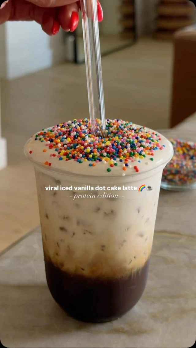 @kalejunkie PROTEIN ICED VANILLA DOT CAKE LATTE 🌈☕️ i wasn’t into the whole dot cake trend but i am when it’s in coffee form! this version has a little protein twist and instead of using those yucky vanilla syrups, im using @pocayourworld sugar free vanilla syrup that also contains a little fiber boost. i keep these in my purse at all times so i can have flavored lattes on the go! i will link them on stories if interested;)⁣
⁣
SAVE this post, SHARE with friends, and FOLLOW me @kalejunkie for more fun, easy recipes!⁣
⁣
Makes 1 drink⁣
1/3 cup So Delicious coco whip ⁣
1/4 cup vanilla protein powder⁣
1 tsp vanilla paste⁣
3 shots espresso⁣
1 packet @pocayourworld vanilla syrup⁣
3/4 cup almond milk⁣
2 tb dot sprinkles ⁣
⁣
First, make the whipped topping. In a bowl, mix together the cocoa whip, protein powder and vanilla paste, until smooth. Place the bowl in the freezer until ready to use. Next, in a glass, add the vanilla syrup and espresso shots, followed by two heaping scoops of ice and the almond milk. Take the coco whip make sure out of the freezer and scoop it on top. Add dot sprinkles for fun and enjoy! #viralrecipes #dotcake #dotcakelatte ⁣