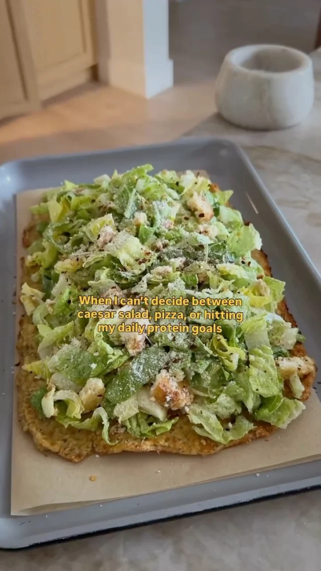 @kalejunkie HIGH PROTEIN CHICKEN CRUST CAESAR SALAD PIZZA, one of my favorite ways to up my protein for the day without a heavy pizza crust—use ground chicken as your base instead. You’ll stay fuller longer too…what a concept 😏 You can make your caesar dressing from scratch or just use store-bought to save time, which is exactly what I did on this day, but not to worry, I included my high protein homemade dressing recipe for you here too, just look below! 35g protein per serving if serving 4 and 70g protein per serving if serving 2! 💪 ⁣
⁣
SAVE this post, SHARE with your friends, and be sure to FOLLOW ME @kalejunkie for more easy, protein forward recipes like this!⁣
⁣
Makes 4 servings⁣
For the chicken crust:⁣
1 lb ground chicken (93/7)⁣
2 eggs⁣
3/4 cup grated parmesan cheese⁣
2 tsp Italian seasoning⁣
1 tsp kosher salt⁣
1/2 tsp ground black pepper⁣
1 tsp crushed red pepper flakes⁣
⁣
Salad:⁣
4 cups romaine lettuce, finely chopped⁣
1 cup croutons of choice⁣
3 tablespoons ranch dressing of choice (store-bought or homemade)⁣
1/4 cup grated parmesan cheese⁣
⁣
My homemade high protein caesar dressing (you will have extra):⁣
1 1/2 cups plain greek yogurt⁣
1 tb dijon mustard⁣
1 anchovy or 1 tb Worcestershire sauce⁣
1 lemon, juiced⁣
3 cloves garlic⁣
3/4 cup grated parmesan cheese⁣
1/2 tsp kosher salt⁣
1/2 tsp ground black pepper⁣
⁣
Preheat oven to 400F. Line a baking sheet with parchment paper and set aside. Add all of the ingredients to make the crust to a large bowl. Mix until well-combined. Transfer the mixture to the baking sheet. Using clean hands, press the ingredients into a rectangle, about 1/4 inch thick. If the mixture is sticky, just add a little oil to the palm of your hands before working the mixture together. Bake for 40-45 minutes, or until the crust is golden brown and firm to the touch. Remove from the oven and if there is any liquid in the pan when you pull it out, carefully pour it out. Set the pan aside. While the crust is in the oven, prepare the salad. Add all salad ingredients to a large bowl and toss with your desired ranch dressing. Transfer the salad on top of the crust, cut i