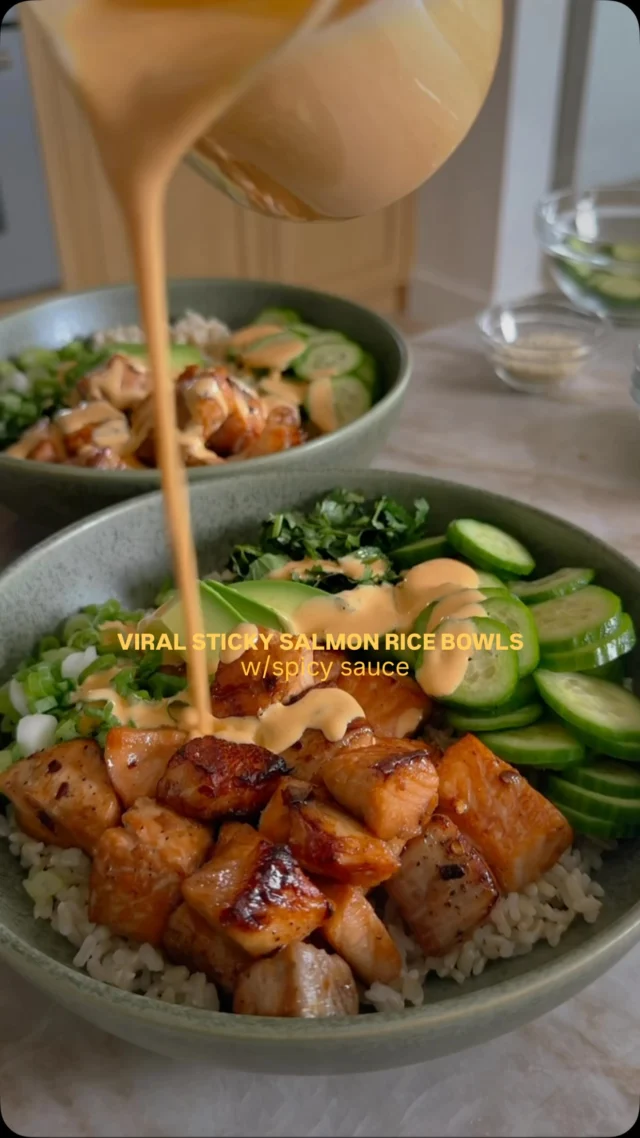 Sticky Salmon Rice Bowls with Spicy Mayo from my friend Jamie’s @everything_delish debut cookbook Everything Delish, which is out today! 🎊 It is so fun to celebrate my friends when they do big things in their careers and this accomplishment is one of them! This recipe is so easy to make and we are giving you the recipe here but comment LINK and we will send the link to order as well! ⁣
⁣
Makes 4 servings⁣
For the Salmon and Rice⁣
¼ cup soy sauce⁣
2 tablespoons honey⁣
1 tablespoon rice wine vinegar⁣
1 tablespoon toasted sesame oil⁣
1 teaspoon red pepper flakes⁣
1 (8-ounce) salmon fillet⁣
Kosher salt and freshly ground black pepper ⁣
1 cup brown rice⁣
⁣
For Assembly⁣
½ cup mayonnaise (or greek yogurt)⁣
¼ cup sriracha⁣
Soy sauce to taste⁣
1 bunch of fresh cilantro, chopped⁣
1 medium avocado, sliced⁣
⅓ large English cucumber, sliced⁣
¼ cup chopped green onions⁣
2 tablespoons sesame seeds⁣
⁣
In a small bowl, whisk together the soy sauce, honey, vinegar, sesame oil, and red pepper flakes. Set aside. Cut the salmon into 1-inch cubes and season with salt and pepper. Place the salmon in a bowl and pour the soy sauce mixture over the top. Cover with plastic wrap and transfer to the fridge to marinate for at least 30 minutes or up to overnight.⁣
⁣
To bake the salmon: Preheat the oven to 400°F. Line a 9x13-inch sheet pan with parchment paper. Spread the salmon on the prepared sheet pan in a single layer and bake for 8 to 10 minutes, until the sauce is beginning to caramelize and the fish is opaque.⁣
⁣
Assemble the bowls: In a medium bowl, stir together the mayo and sriracha. Set aside. In another medium bowl, stir together the soy sauce and cilantro. ⁣
⁣
Set aside. Transfer the cooked rice to a platter or individual bowls. Top with the salmon bites, avocado, and cucumbers. Finish with the green onions, sesame seeds, spicy mayo, and a sprinkling of the cilantro soy sauce.⁣