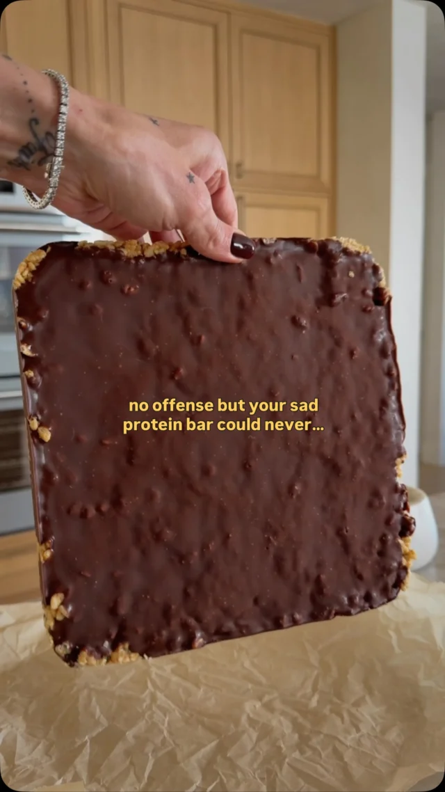 @kalejunkie 10g Protein Peanut Butter Rice Crispy Bars! I look forward to a sweet treat each day and this one is an added bonus with 10g protein per bar and it’s made with better for you ingredients! The best part? So easy to make and stash in your fridge or freezer for a grab and go treat! ⁣
⁣
Follow me @kalejunkie for more protein & fiber forward meals and treats!⁣
⁣
Makes 9 bars (or more if you slice smaller)⁣
1/3 cup honey⁣
3 tablespoons coconut oil ⁣
3/4 cup creamy peanut butter⁣
3 cups rice crispy cereal⁣
1/4 cup hemp hearts ⁣
⁣
pb chocolate topping⁣
3/4 cup chocolate chips (I used @hukitchen)⁣
1/3 cup creamy peanut butter⁣
flaky salt for topping⁣
⁣
In a large pot over medium-low heat, add the honey and coconut oil. Gently whisk until combined. Add the peanut butter and continue whisking until smooth. Remove pot from the heat. Add the rice crispy cereal and hemp hearts, mixing until the cereal is fully coated. Transfer the mixture to a parchment lined 8x8 baking dish (or just grease the pan well). Press the cereal firmly into the pan using a spatula. If it’s sticky, add a little oil to the palm of your hands to press down. Next, add the chocolate chips and peanut butter to a small bowl and microwave in 2-3, 30-second increments stirring in between, until completely melted and smooth. Once melted, pour over the top in an even layer. Freeze for at least 3 hours or overnight. Remove from the pan, slice into squares and add flaky salt if desired, and enjoy. Store in a covered container in the fridge or freezer. ⁣