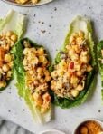 Three romaine lettuce leaves stuffed with the smashed chickpea curry salad