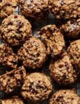 A bunch of the vegan chocolate chip cookie zucchini breakfast cookies, sitting on a cooling rack.