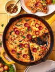 An image of the easy pizza frittata, sitting in a cast iron skillet on a countertop